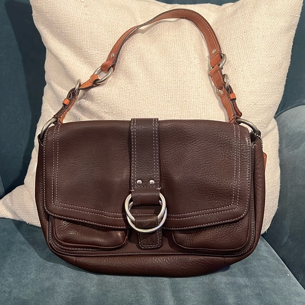 Coach eggplant shoulder bag with camel colored strap and silver hardware.